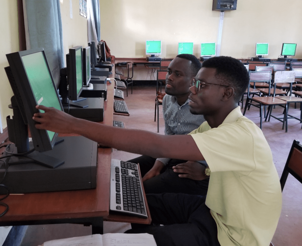 Our training officer, Bahati Kamanga, conducting a one-on-one session with the ICT teacher from Korongoni Secondary School in Kilimanjaro on how to manage user accounts on a computer. 